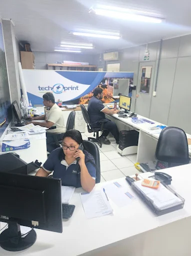 Equipe de produção da TechPrint operando maquinário de impressão digital